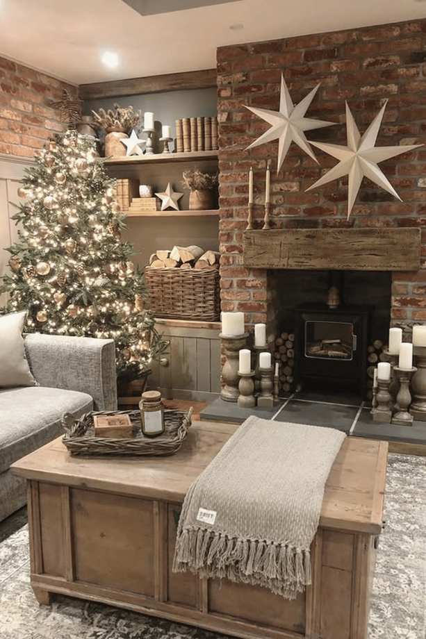 Living room with a flocked Christmas tree and gold ornaments.