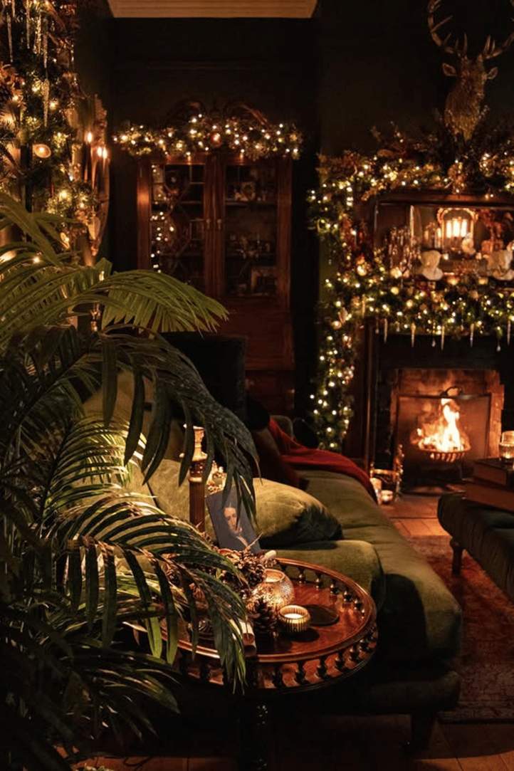 Sitting room with a small sofa, armchair, rug, and warm lighting.