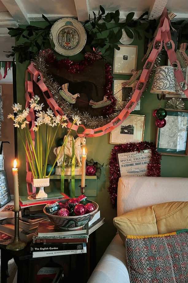 Cozy corner with a wingback chair, stack of books, warm lamp, and soft holiday accents.