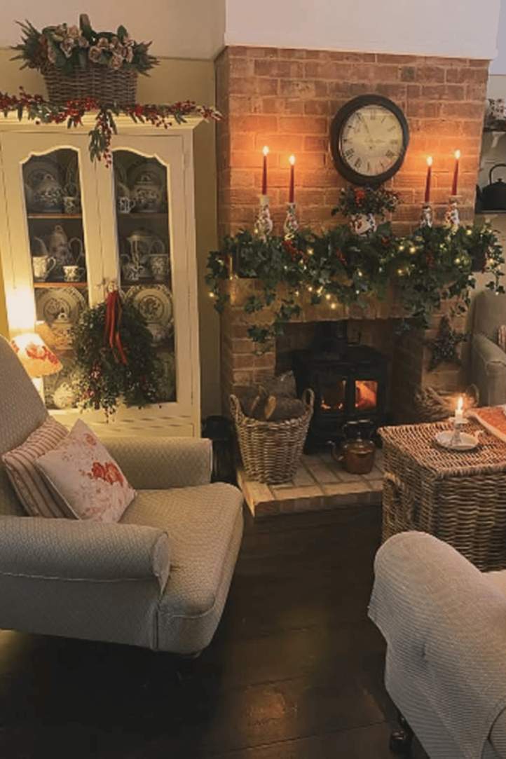Modern farmhouse living room with white shiplap, oversized wreath, and abundant evergreen garlands.