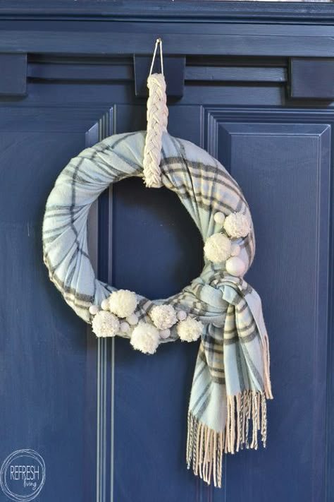 Soft oatmeal chenille scarf wreath hanging in sunroom window frame under natural soft winter daylight.