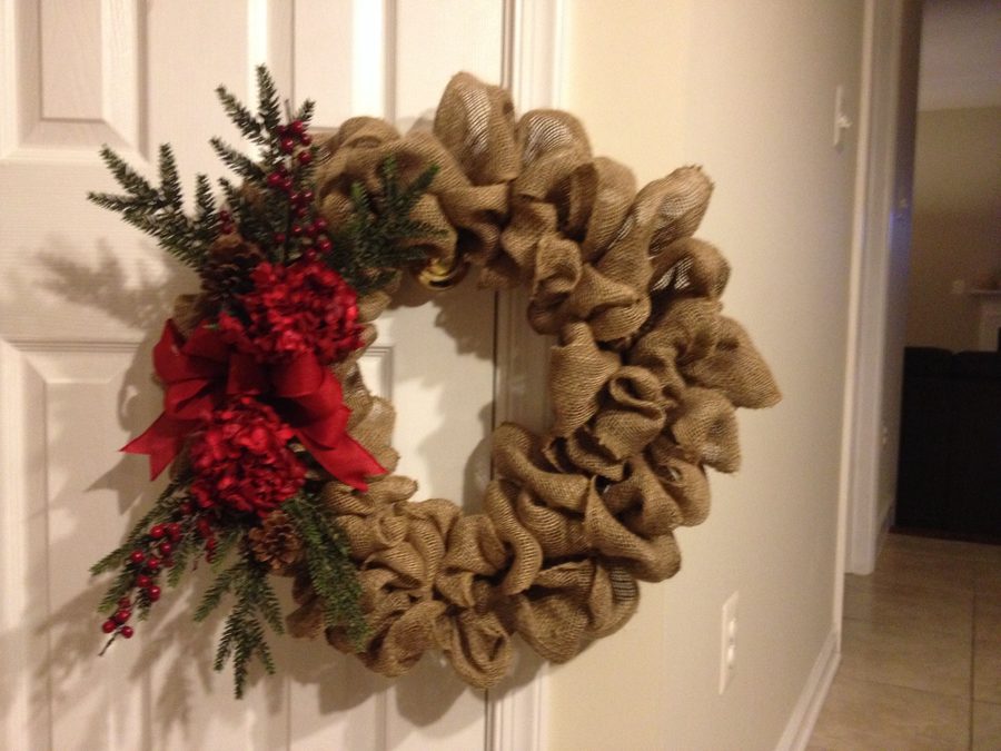 Black buffalo check scarf wreath on kitchen pantry door with marble counter and warm lighting