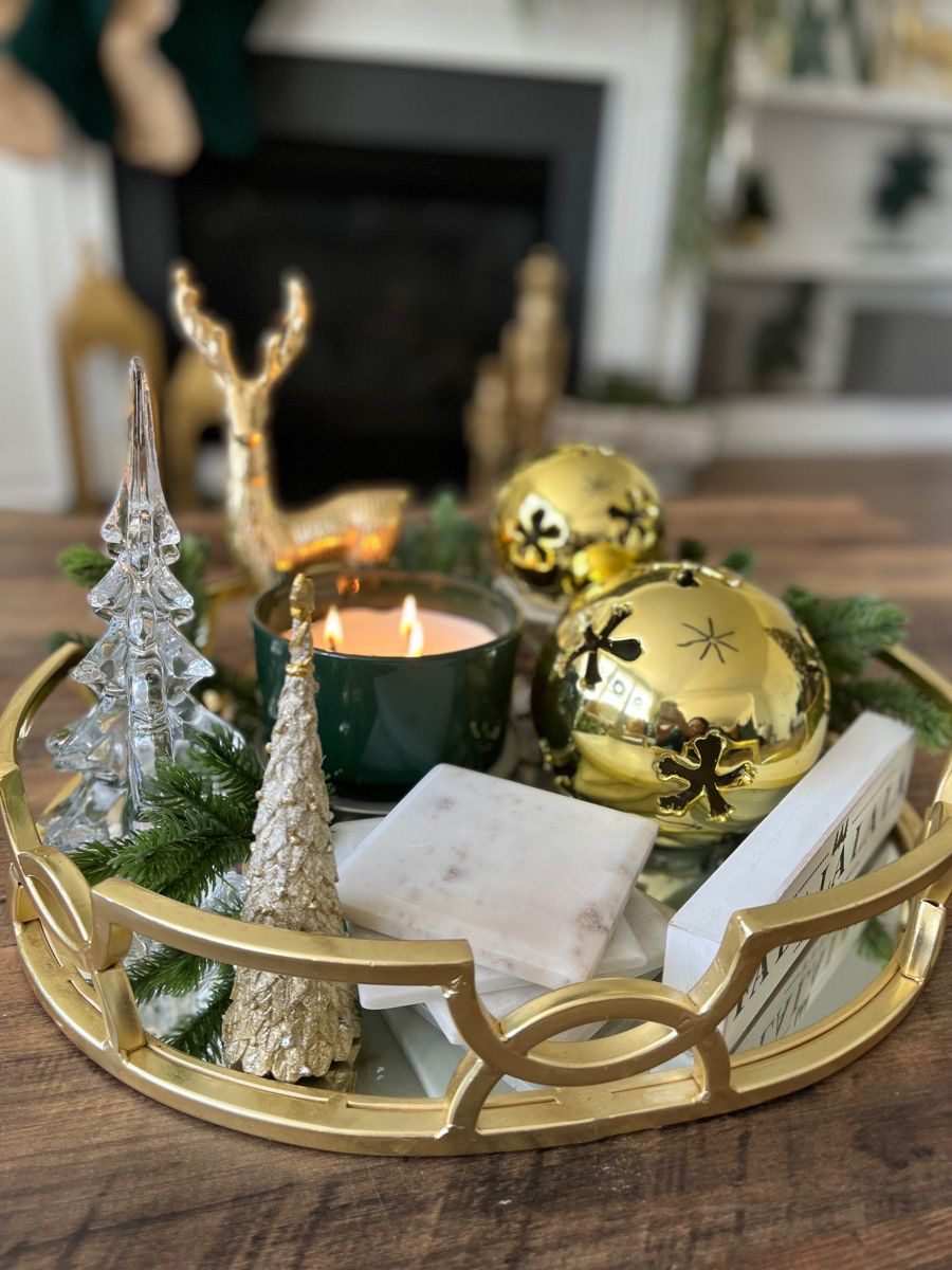 Small coffee table styled with a folded plaid blanket, a boucle pillow, and wooden beads.
