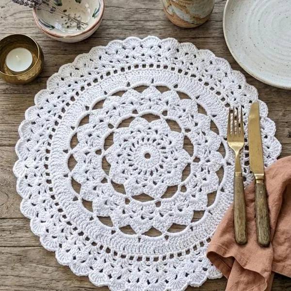 French country dining room mahogany table adorned with white lace crochet placemats and crystal glass