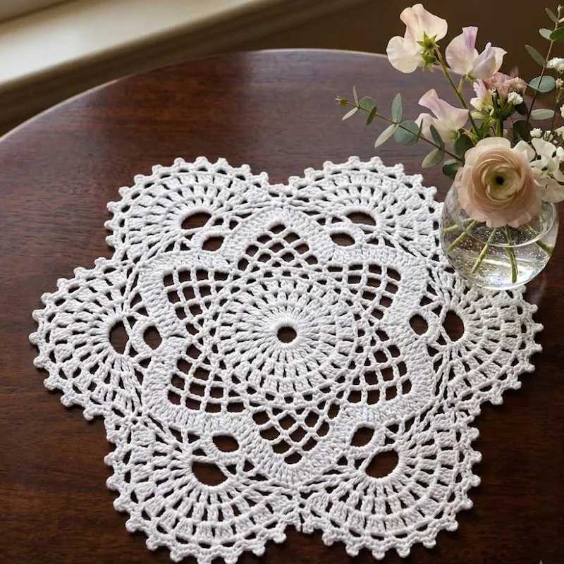 Modern kitchen island marble countertop displaying a stiffened beige crochet bowl filled with fresh citrus fruit