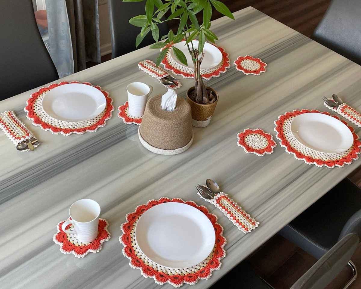 Bohemian sunroom round wooden bistro table covered with a vibrant multi-colored crochet mandala centerpiece