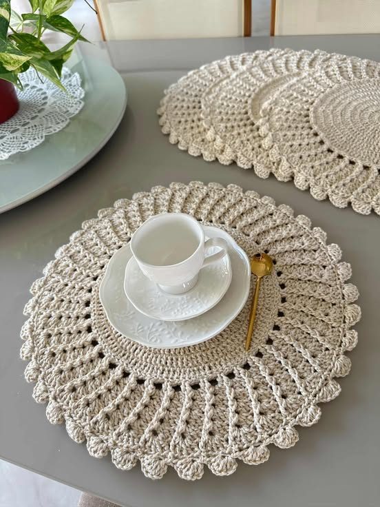 Dining room table with crochet table decorations, linen runner, wooden chairs, warm ambient lighting.
