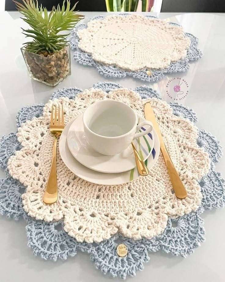 Kitchen island table with crochet table decorations, white doilies, light oak wood, cool lighting.