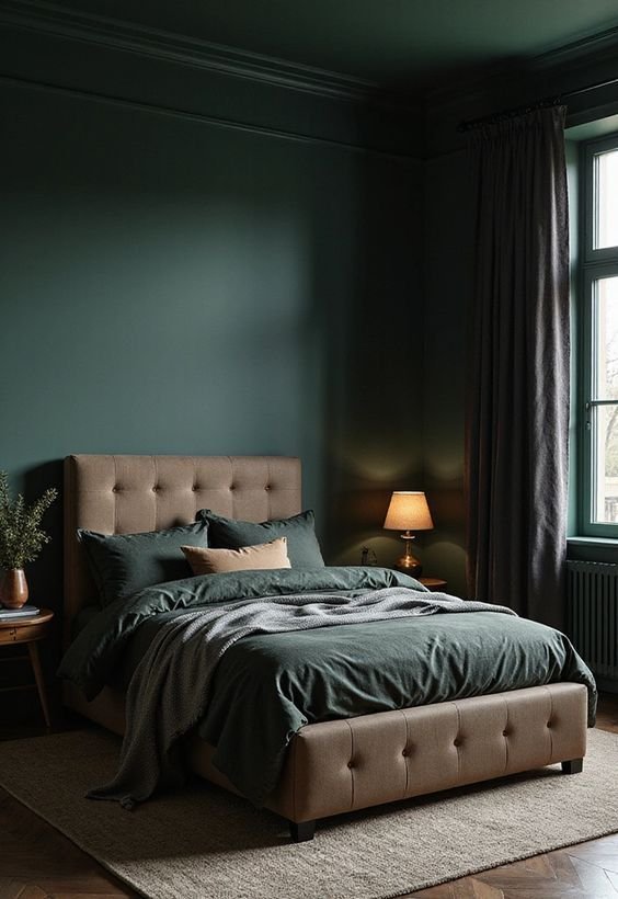 Monochromatic dark pine green male bedroom with matching green trim tailored grey bedding and brass lighting