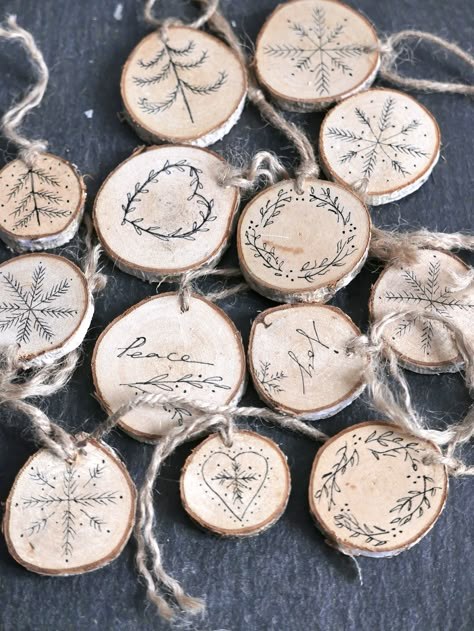 Personalized Christmas tree branch featuring black ink calligraphy monogram wood slice ornaments with soft lighting 13 words