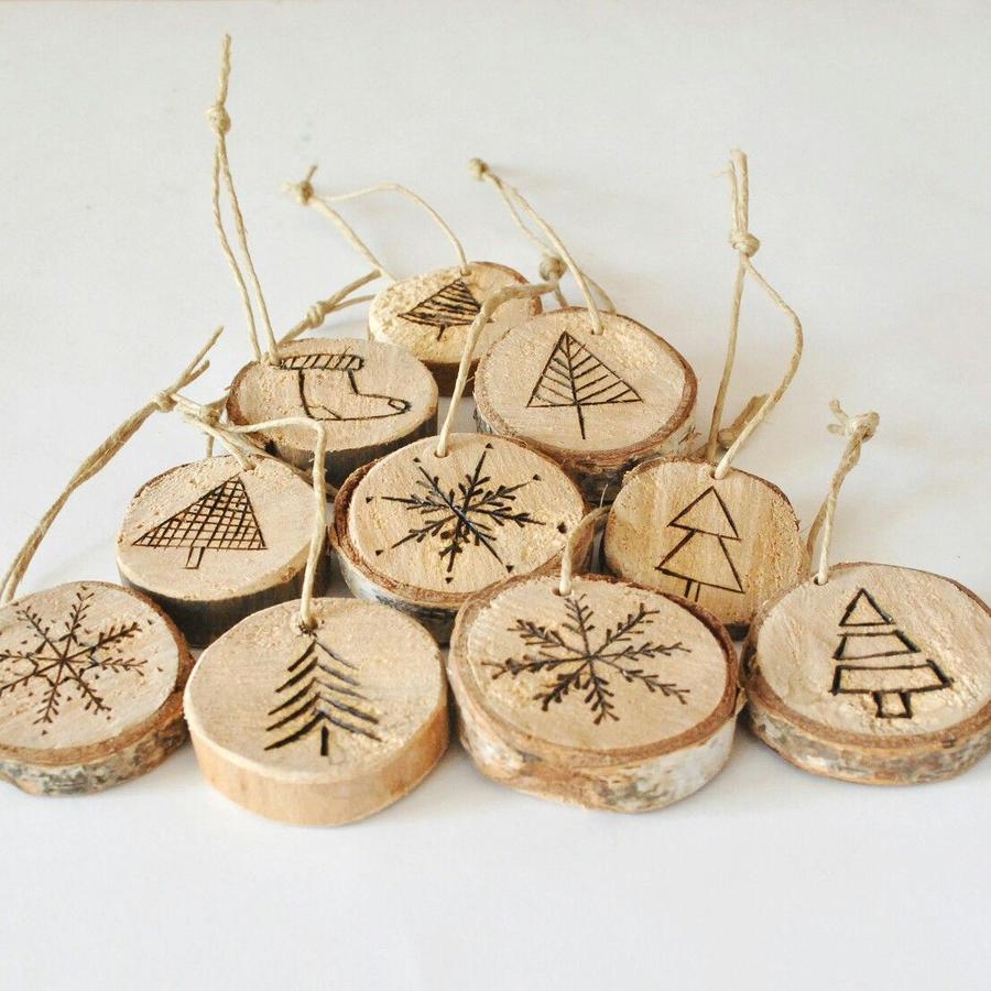 Sunlit sunroom tree styled with pressed winter fern foliage on natural wood slice ornaments and lights 13 words
