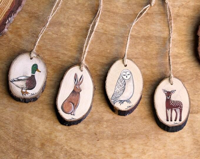 Kitchen wall peg rack with photo wood slice ornaments, rosemary sprigs, soft warm task lighting.