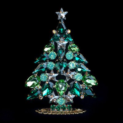 Crimson ruby red gem christmas tree on black granite sideboard with warm mood accent lighting