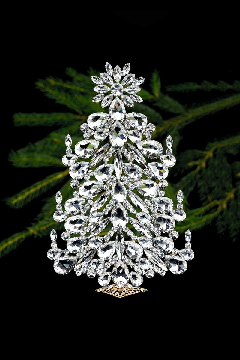 Iridescent crystal gem christmas tree on glass side table with diffused daylight and warm lamps