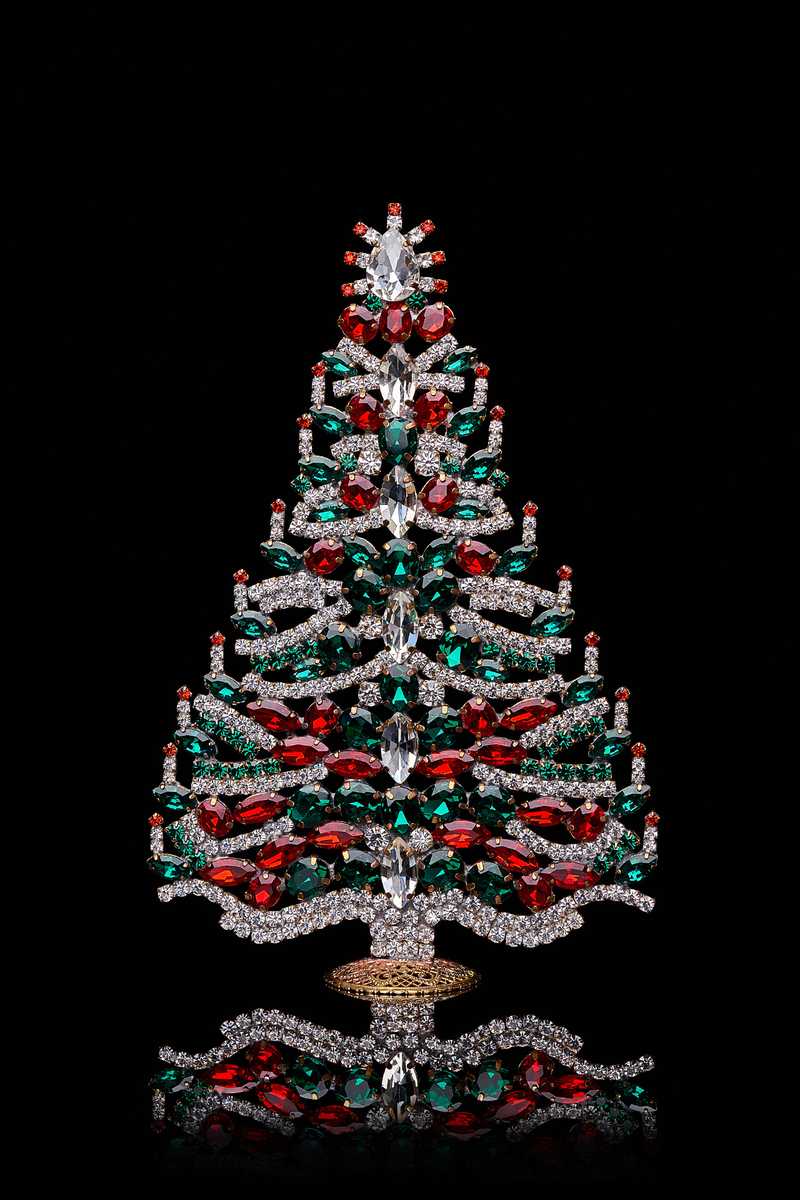 Dark smoky quartz gem christmas tree on dark walnut desk with dim warm ambient LED lighting
