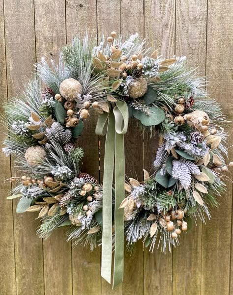 Entryway hallway with console table, macrame wreath, pine cones, dark wood, warm sconce lighting.