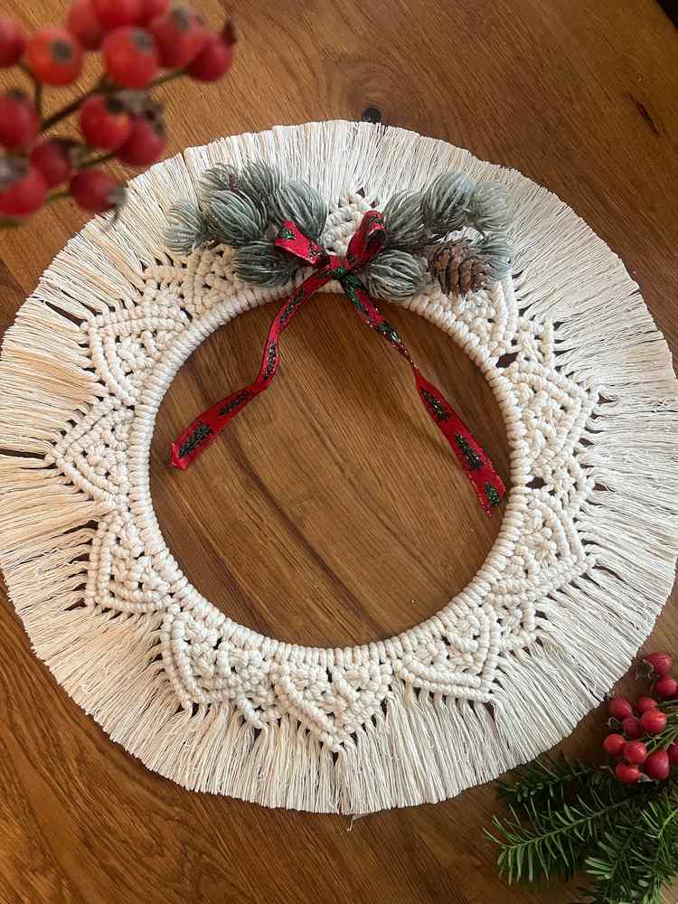 Hallway wall, oversized wooden bead wreath, green pine, neutral rug, soft hallway lighting.