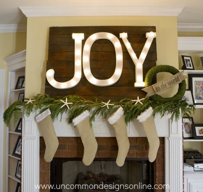 Cozy bedroom reading nook with woven rattan snowflake marquee light and soft boucle chair.