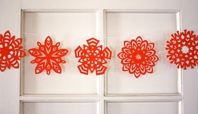 Modern entryway featuring an intricate paper origami wreath on an oak door beside a marble console table.