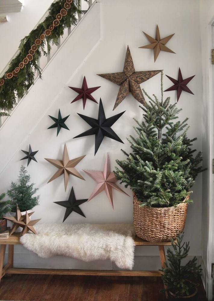 Kitchen breakfast nook featuring cinnamon stick diy christmas star decorations hanging near open oak shelving and ceramics