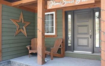 Master bedroom featuring large rustic wooden slat star above upholstered bed warm cozy textiles