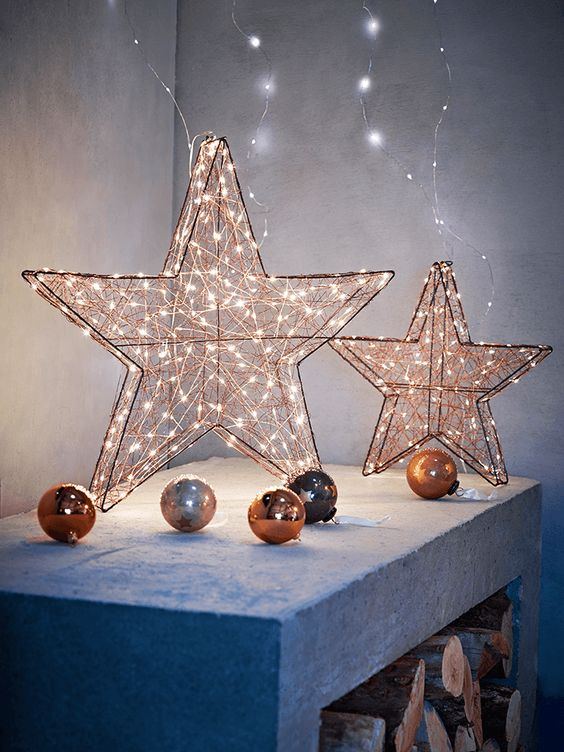 Modern kitchen island featuring matte black metal wire stars filled with fresh eucalyptus branches