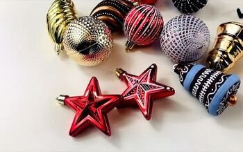 Dining room table with terracotta ombre glass ornaments, woven runner, oak dining chairs, soft lighting.