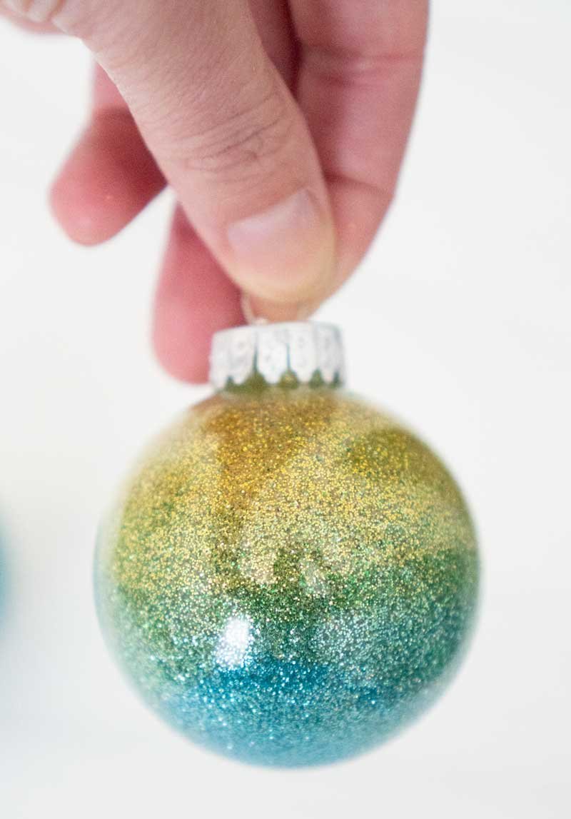 Sunroom christmas tree featuring terracotta amber diy ombre glass ornaments illuminated by natural warm daylight.