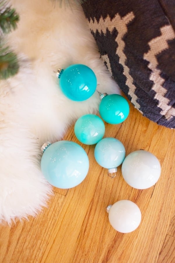 Master bedroom nightstand styled with champagne pearl diy ombre glass ornaments and warm bedside lamp light.