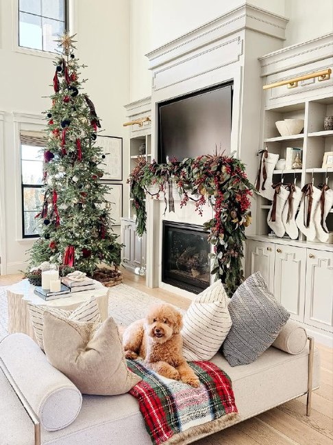 Handmade tartan ornaments on a rustic wooden tree branch, soft natural lighting.