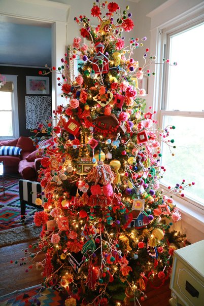 Bright living room tree with sheer champagne organza ribbon, white slipcovered sofa, soft daylight