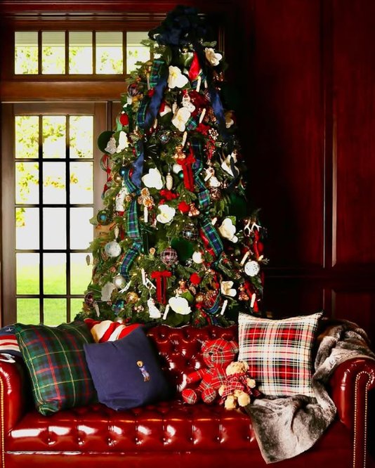 Fully decorated tree with crystal ornaments, gold leaf accents, soft candlelight, warm glow.
