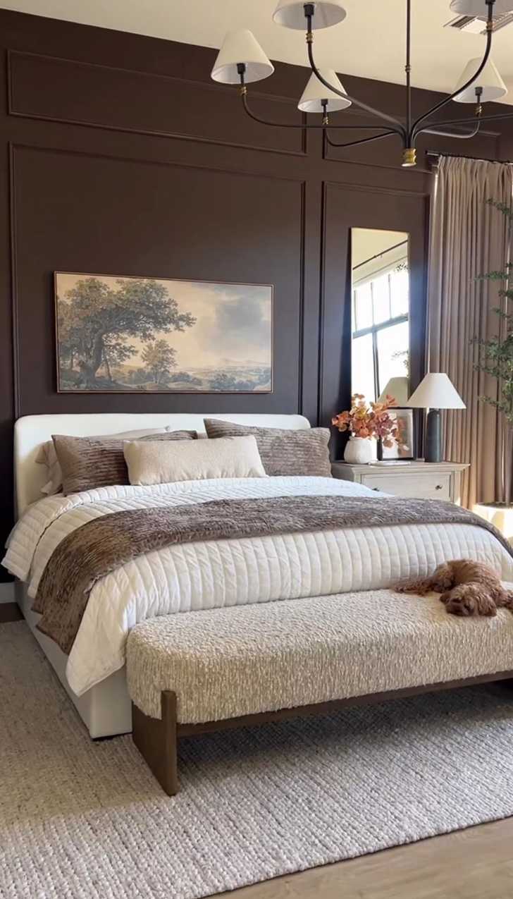Bedroom with espresso brown moulding accent wall and a soft boucle bench