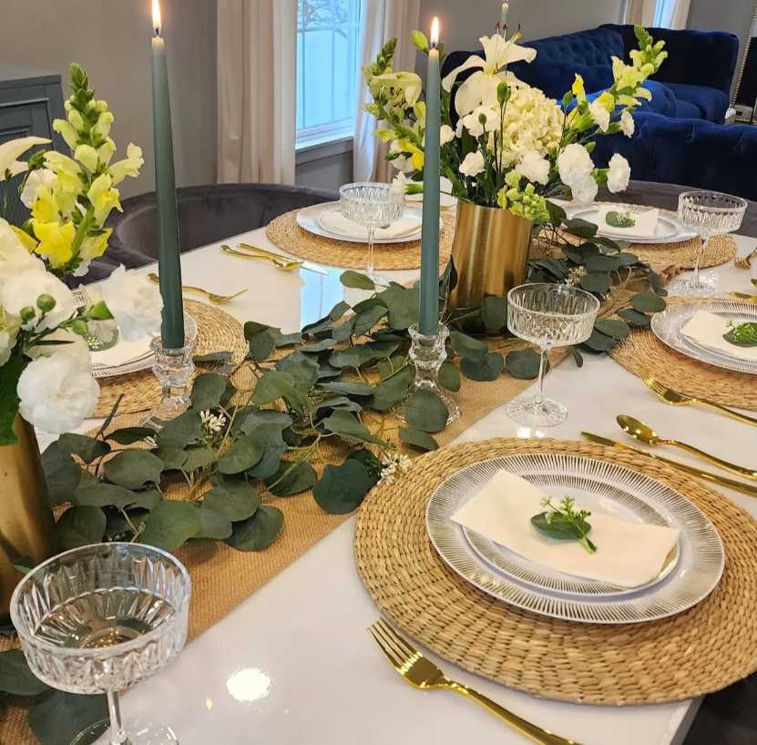 Contemporary dining, eucalyptus garland, gold-rimmed crystal glasses, ivory tablecloth, soft ambient lighting