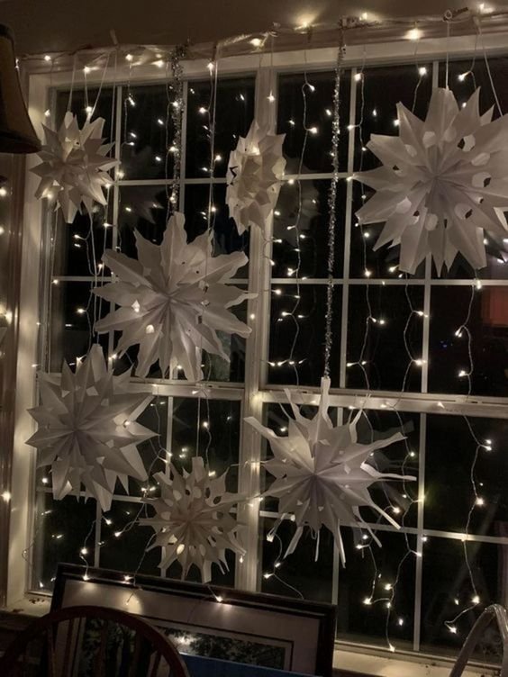 Fairy lights wrapped around the window frame and hanging down the glass.