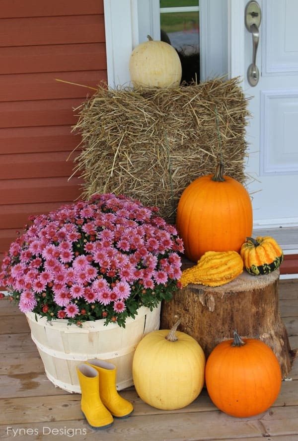A dining table set with white pumpkins painted with gold leaf accents.
