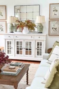 A fireplace hearth with a woven basket filled with logs and faux fur blankets.