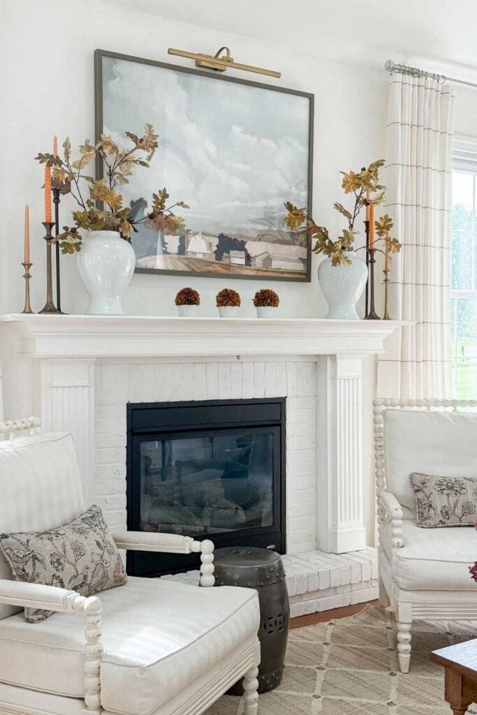 A gallery wall featuring pressed leaves and autumn-inspired botanical prints.
