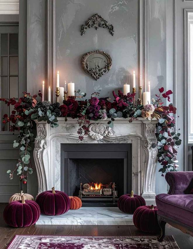 Mantel styled with clay pots, terracotta pumpkins, and warm orange dried florals.
