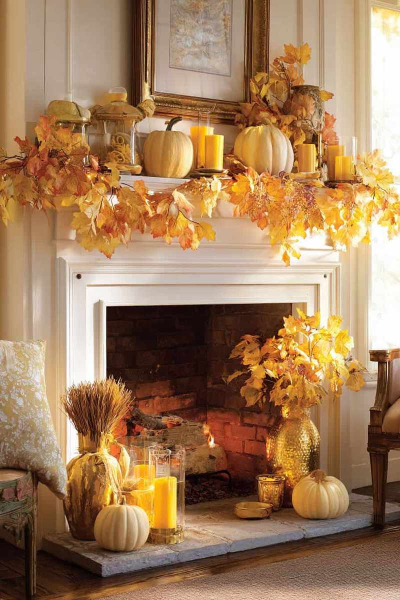 A monochrome mantel featuring black and white pumpkins and a bold, graphic framed print.