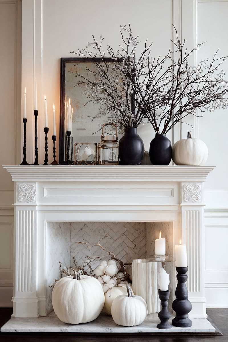 A wooden mantel featuring cedar boughs, copper mugs, and white candles.