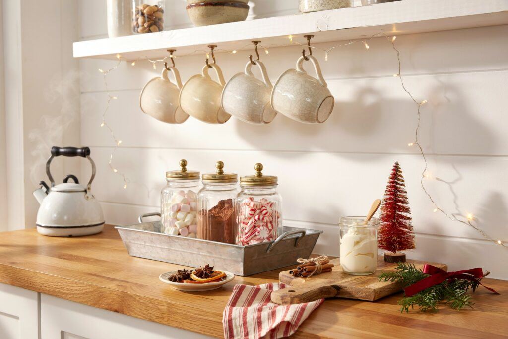 Copper cookware hung above a kitchen island decorated with bowls of cloves and cinnamon.