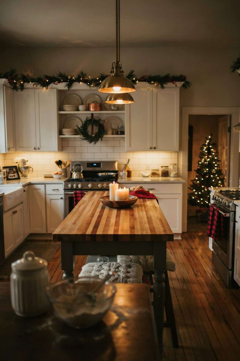 A kitchen window sill decorated with a row of colorful snowy bottle brush trees.