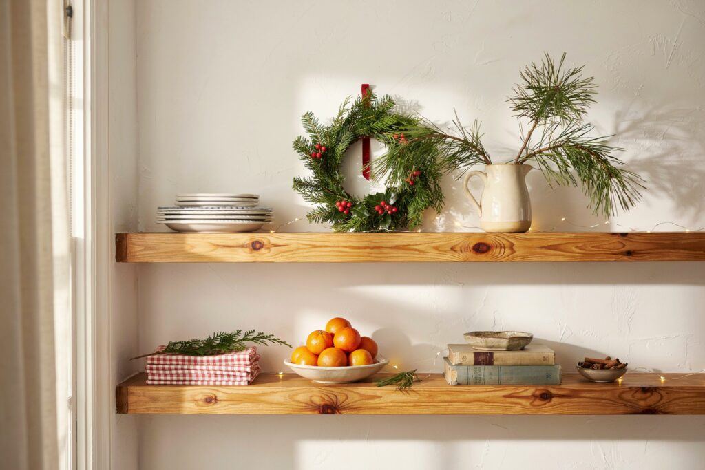 A kitchen hood decorated with a handmade garland of dried oranges and cinnamon sticks.