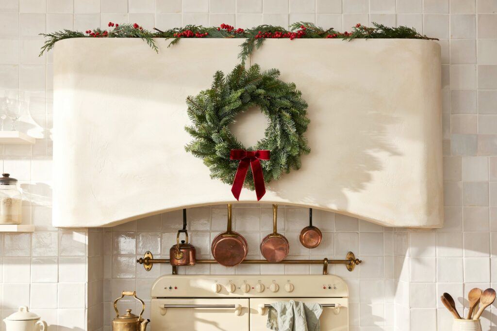 A long kitchen counter lined with assorted metal and glass holiday lanterns.