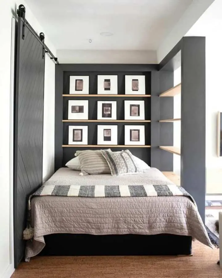 Bedroom with a recessed niche housing framed artwork behind an upholstered headboard, creating a gallery effect.