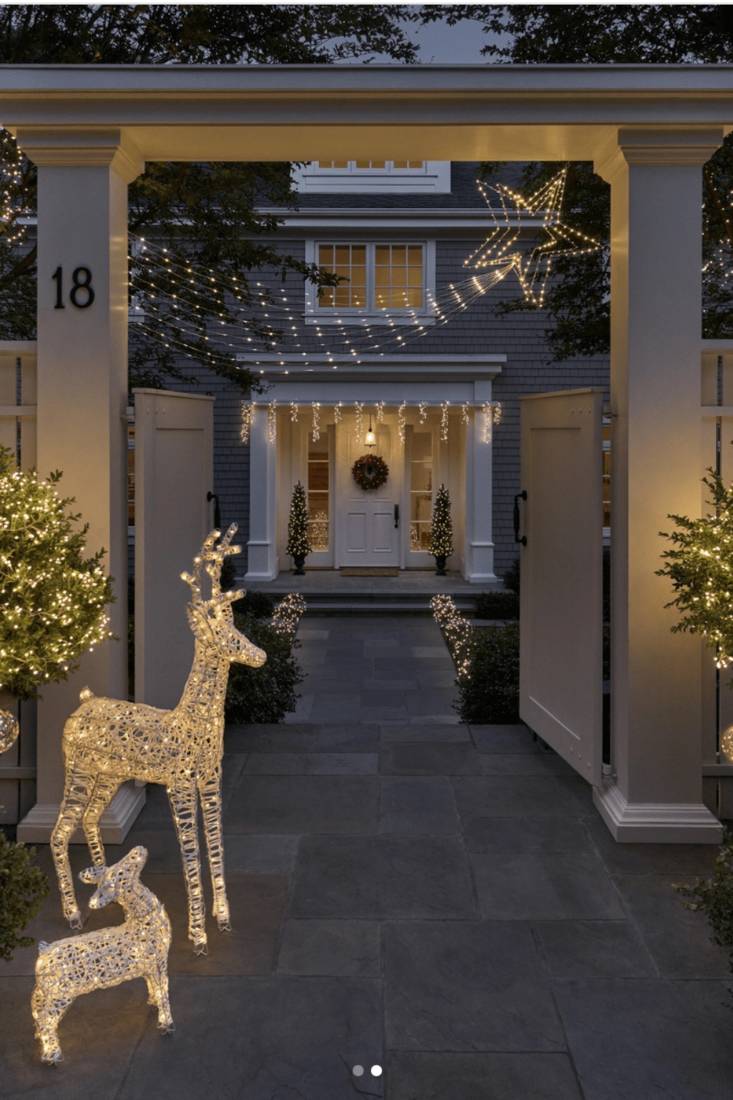 A modern porch featuring high-end, metallic outdoor christmas decorations and clean lines.