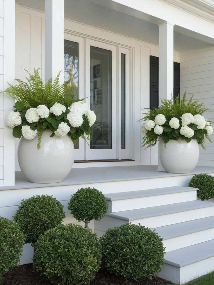 Front porch with charcoal sofa, gold floor lamp, and soft gray rug
