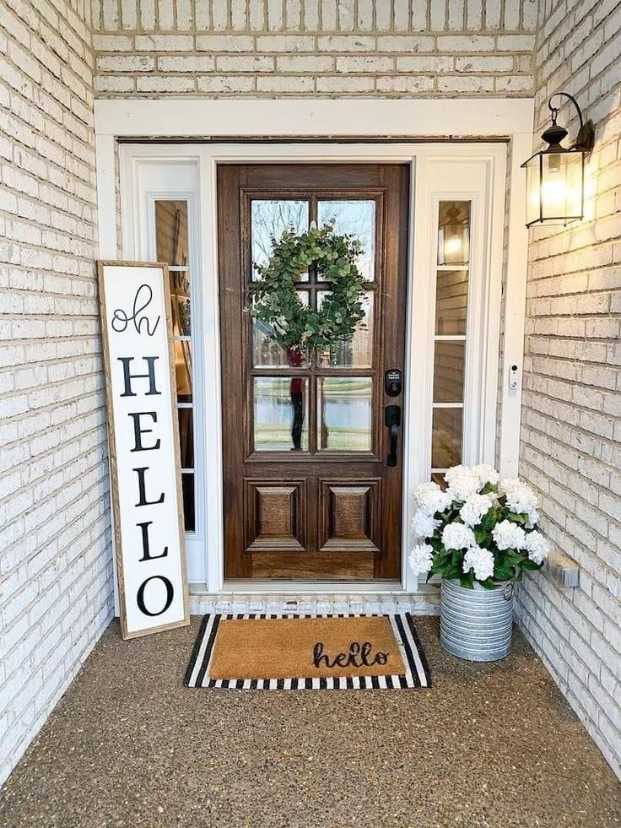 Front porch with hanging macramé planters, leafy tropical plants, and bamboo lighting