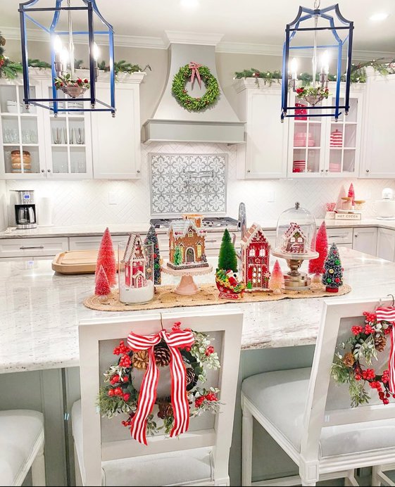 Row of gingerbread men lined up on white kitchen island with icing details.